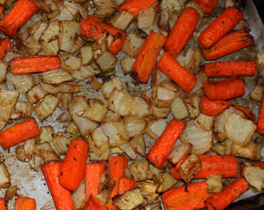 Caramelized oven-roasted vegetables on a baking tray