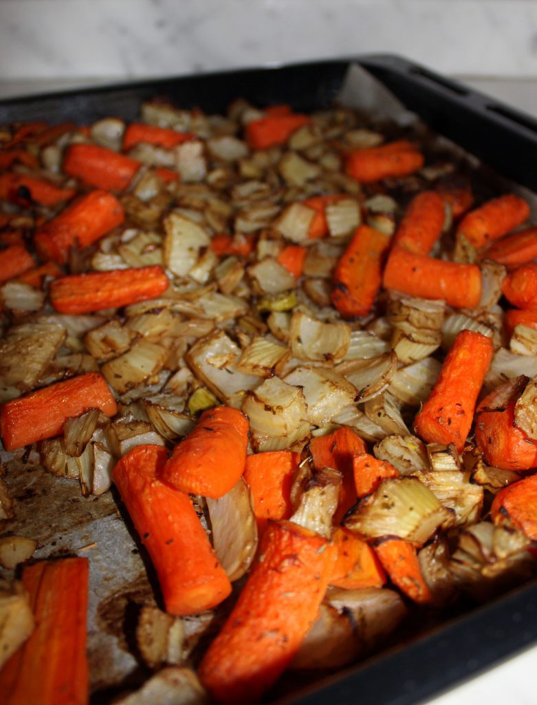 Caramelized oven-roasted vegetables on a baking tray
