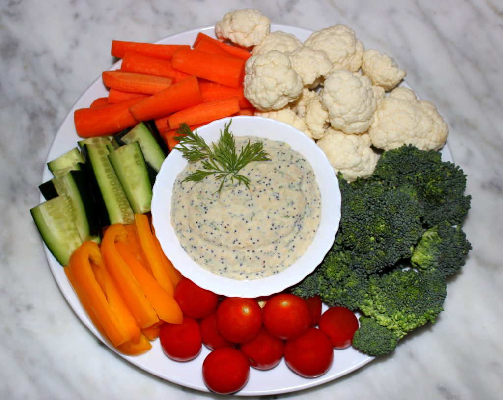 Plate of vegetables and a bowl of veggie dip in the middle