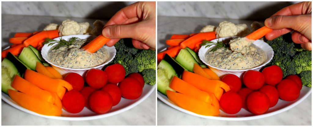 A carrot stick being dipped in the veggie dip