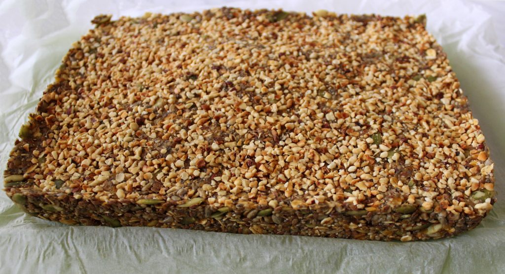 Ready mixture for healthy vegan no-bake protein bars before cutting in bars