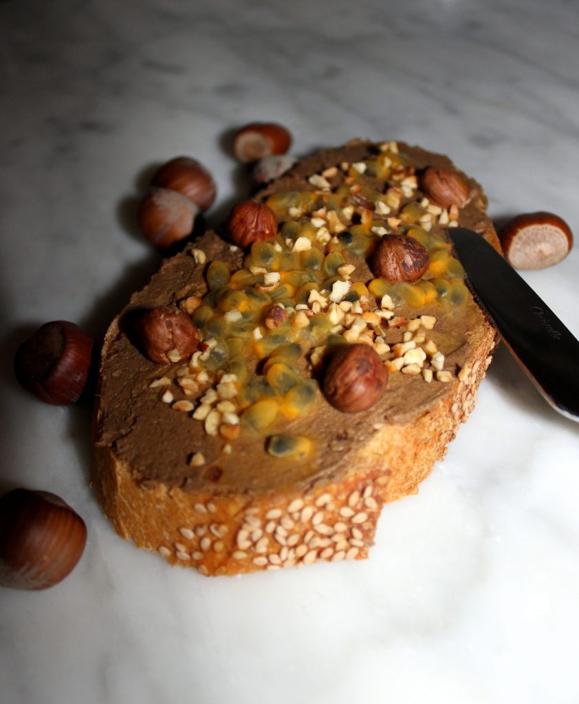 A slice of bread with vegan Nutella with passion fruit