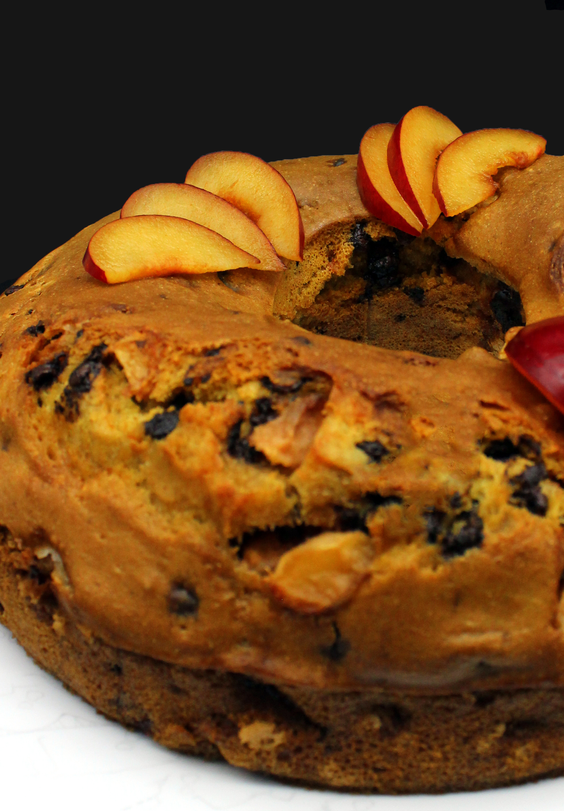 Vegan bundt cake with plums and chocolate chips in closeup