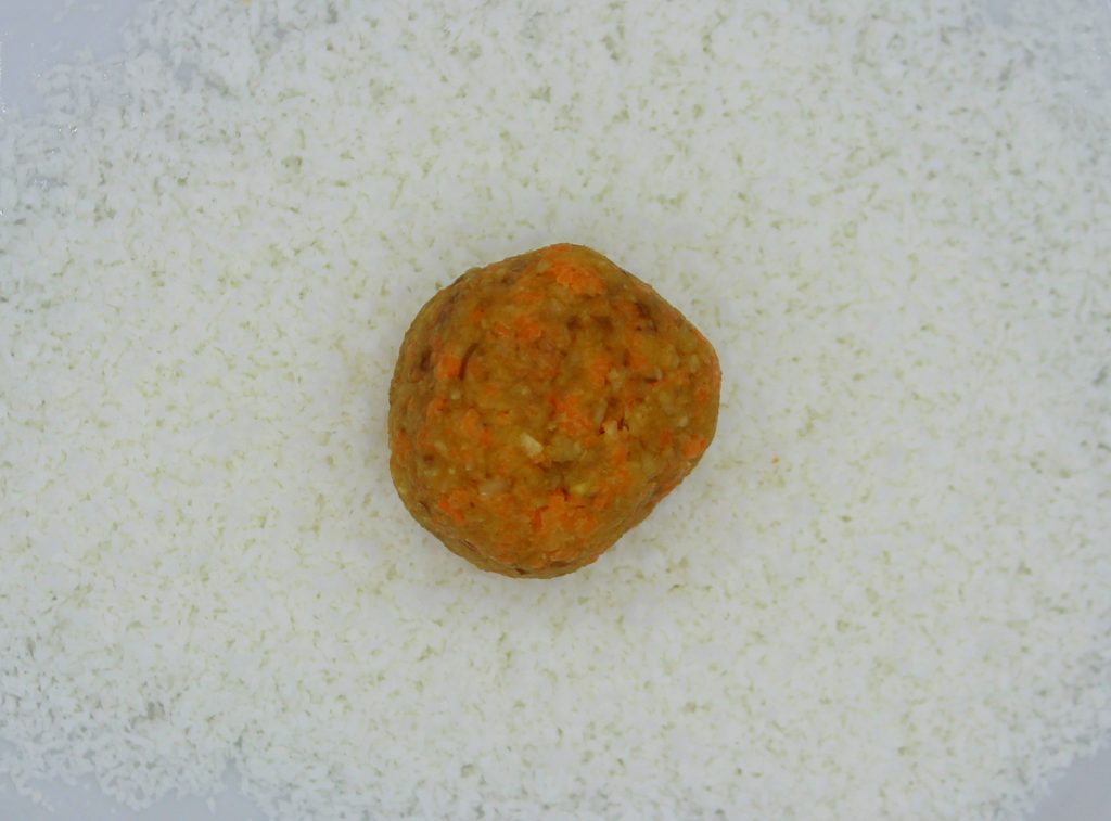 Healthy vegan carrot energy ball before covering with shredded coconut