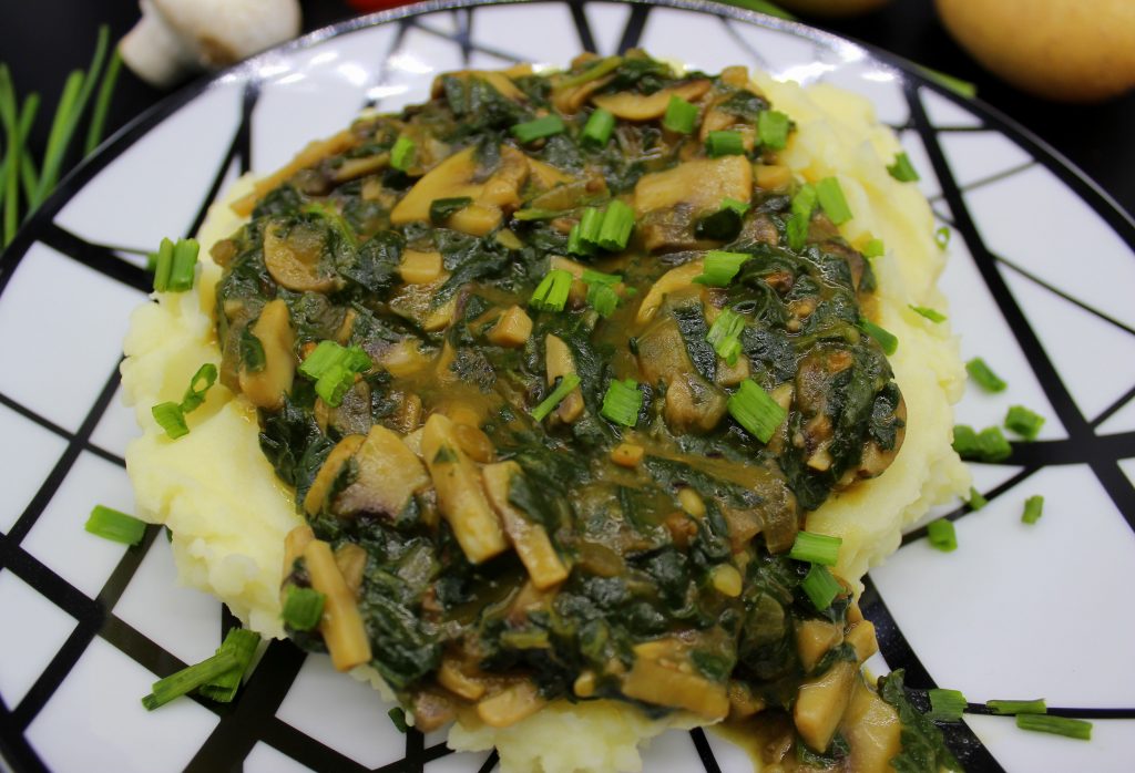 Vegan mashed potatoes with mushroom and spinach gravy