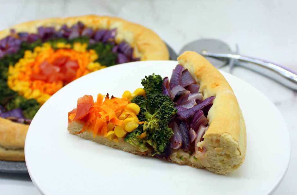 A slice of easy vegan rainbow pizza